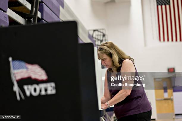 Voter fills out a ballot at a polling location during the primary election in Strasburg, Virginia, U.S., on Tuesday, June 12, 2018. In the Shenandoah...