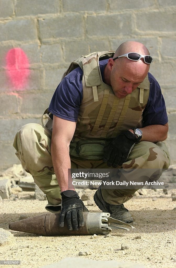 Jimmy Roodt An American explosives expert inspects a bomb that was later exploded ...
