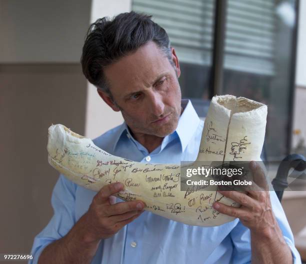Tommy John III holds the original cast signed by the 1974 Los Angeles Dodgers from the surgery performed on his father, former Major League Baseball...