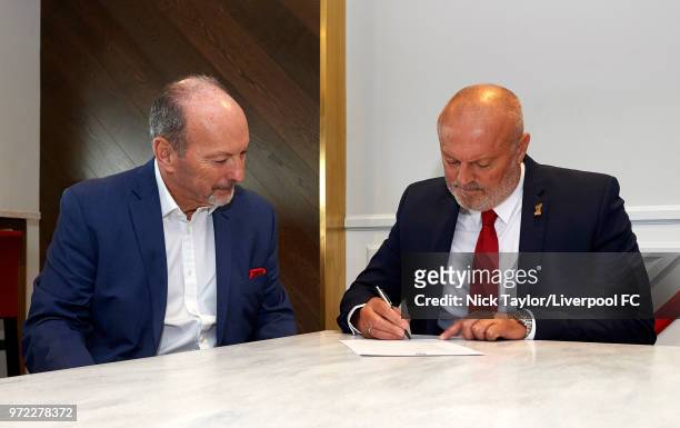 Neil Redfearn signs to become the new manager of Liverpool Ladies with Liverpool FC CEO Peter Moore at Anfield on June 8, 2018 in Liverpool, England.