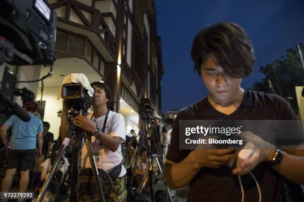 Members of the media stand outside the St. Regis hotel, where North Korean leader Kim Jong Un was staying, in Singapore, on Tuesday, June 12, 2018....