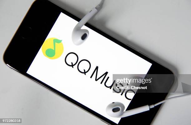 In this photo illustration, the logo of the music streaming service QQ Music is displayed on the screen of an iPhone on June 12, 2018 in Paris,...