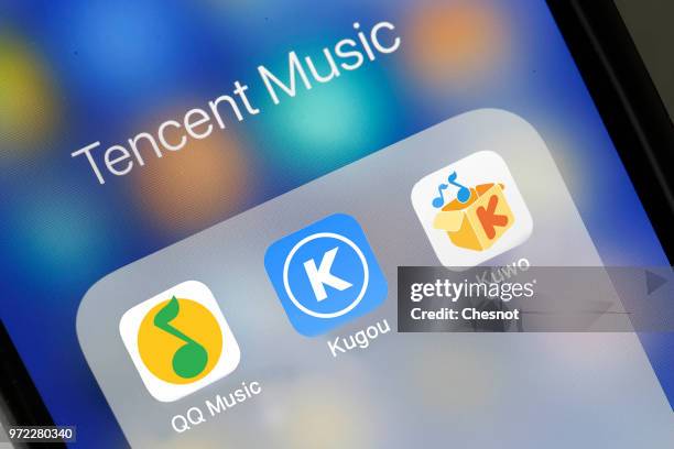In this photo illustration the logos of QQ Music, Kugou and Kuwo are seen on the screen of an iPhone on June 12, 2018 in Paris, France. QQ Music,...