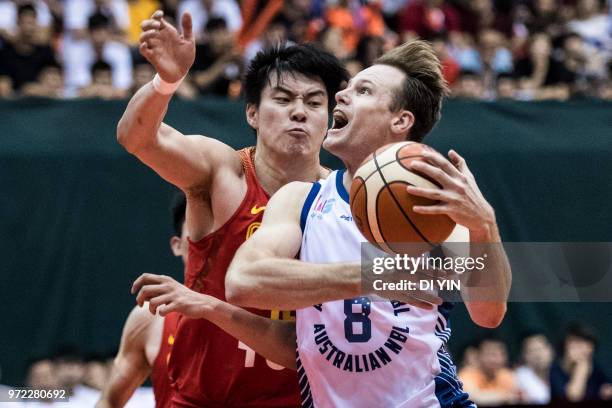 Brad Newley of Australian controls the ball against Dong hanlin of China during the 2018 Sino-Australian Men's Internationl Basketball Challenge...