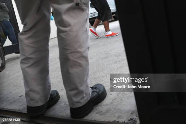 Undocumented immigrants in shackles arrive to a U.S. Federal court on June 12, 2018 in McAllen, Texas. Thousands of migrants continue to cross into...