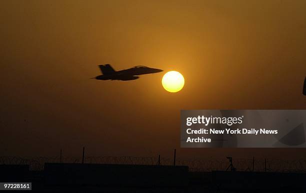 An F-18 fighter flies off to patrol the no-fly zone over Iraq from a 75th Fighter Squadron base near the Iraqi border.