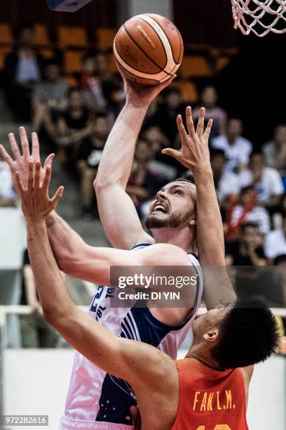 Angus Brandt of Australia shoots the ball against Fan Ziming of China during the 2018 Sino-Australian Men's Internationl Basketball Challenge match...