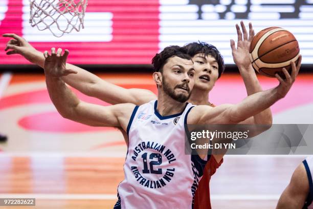 Angus Brandt of Australia gets a rebound against Wang Zhelin of China during the 2018 Sino-Australian Men's Internationl Basketball Challenge match...