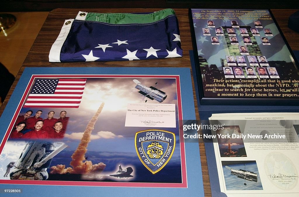 An NYPD flag and other memorabilia are on display at One Pol