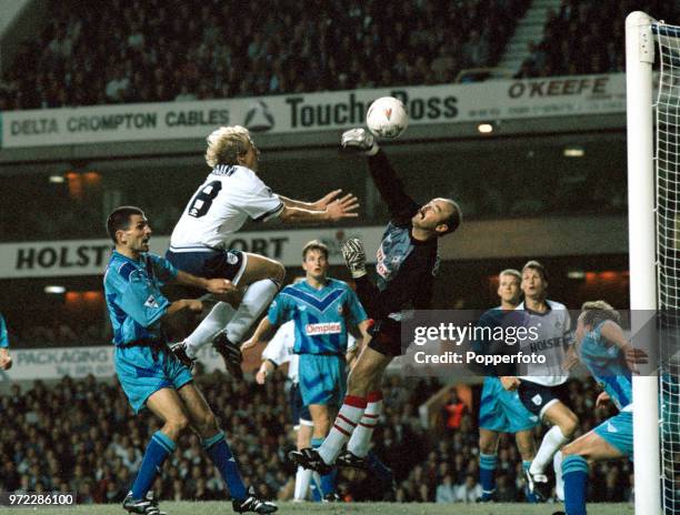 Bruce Grobbelaar of Southampton punches the ball away from Jurgen Klinsmann of Tottenham Hotspur at White Hart Lane on September 12, 1994 in London,...