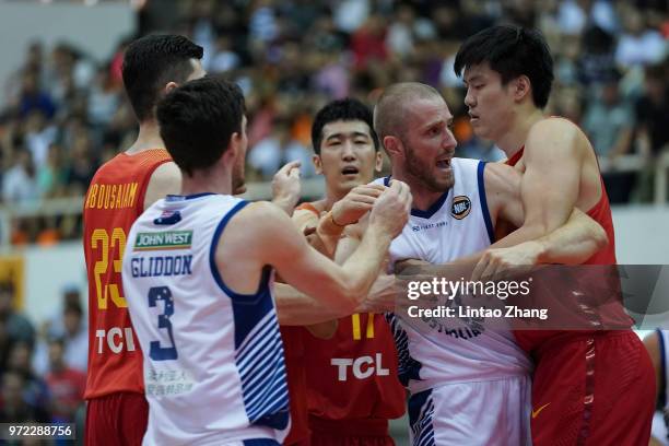 Jesse Wagstaff of Australia tussles with Dong Hanlin of China during the 2018 Sino-Australia Men's Internationl Basketball Challenge match between...