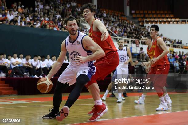 Angus Brandt Australia Looks to pass against Wang Zhelin of China during the 2018 Sino-Australian Men's Internationl Basketball Challenge match...