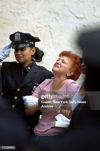 Ana Fernandez grieves as the coffin of her daughter, rookie NYPD Officer Marlene Rivera, is carried into the Metropolitan International Church in...