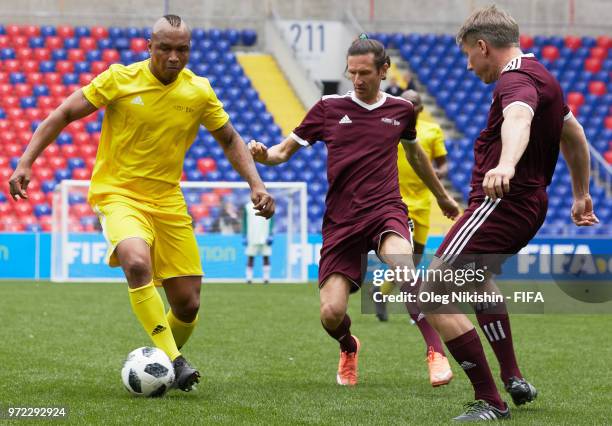 Kalusha Bwalya of CAF vies for the ball with Alexey Smertin and Alexey Sorokin of Russian FA during FIFA Congress Delegation Football Tournament at...