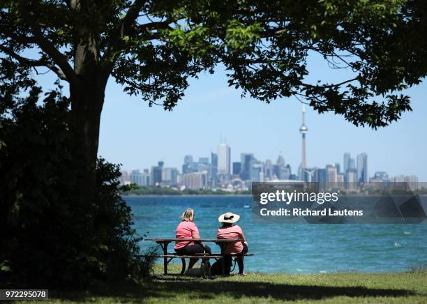 June 11: With the official start of summer just around the corner, two women take a break from their dog walk in West Humber Bay Park west enjoying...