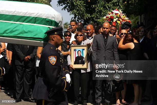 Andrea Reyes gestures as she holds a photo of her deceased son Police Officer Alexander Felix during funeral at Our Lady of Lourdes Church at 463...