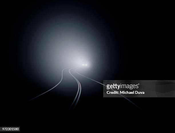 curvy roadway with car in the distance - driving in fog stock pictures, royalty-free photos & images