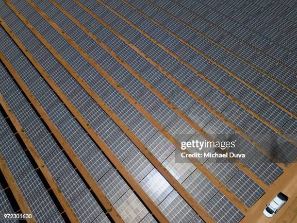 large array of solar panels with maintenance truck - baggy green stock pictures, royalty-free photos & images
