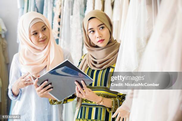 muslim women in wedding dress store presenting a new collection - wedding vendor stock pictures, royalty-free photos & images