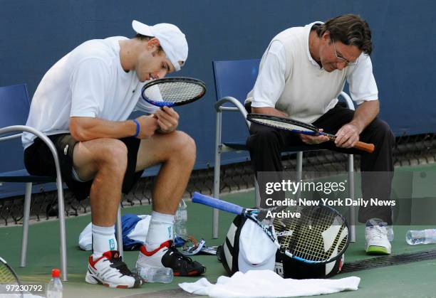 Andy Roddick and his coach, tennis great Jimmy Connors, inspect their racquets on a practice court at the USTA Billie Jean King National Tennis...