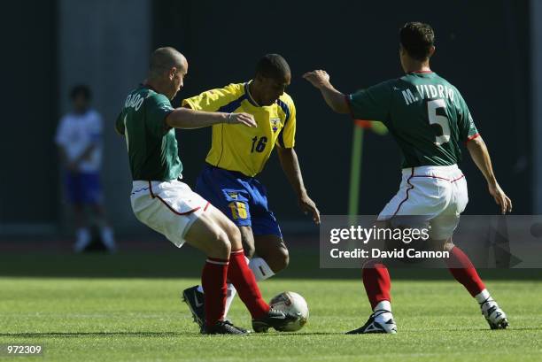 Cleber Chala of Ecuador takes the ball past Gerardo Torrado and Manuel Vidrio of Mexico during the FIFA World Cup Finals 2002 Group G match played at...