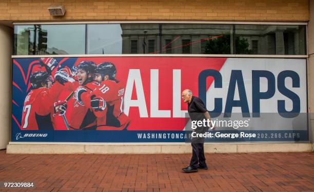 Man walks past a Washington Capitals ice hockey team billboard on June 4, 2018 in Washington, D.C. The nation's capital, the sixth largest...