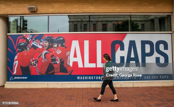 Woman walks past a Washington Capitals ice hockey team billboard on June 4, 2018 in Washington, D.C. The nation's capital, the sixth largest...