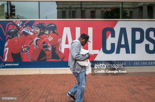 Man walks past a Washington Capitals ice hockey team billboard on June 4, 2018 in Washington, D.C. The nation's capital, the sixth largest...