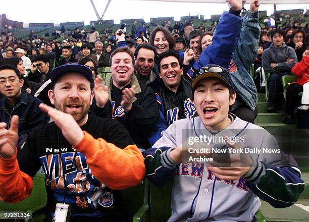 Andy Weinstein and Takashi Yoshioka are backed up by friends as they cheer on the New York Mets at game between the Mets and the Seibu Lions at the...