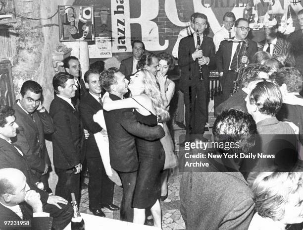 Anita Ekberg dancing with actor Gerard Herter at a party in Rome, Italy.