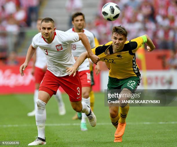 Poland's Artur Jedrzejczyk and Lithuania's Fiodor Cernych vie for the ball during the international friendly football match between Poland and...