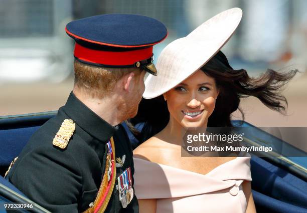 Prince Harry, Duke of Sussex and Meghan, Duchess of Sussex travel down The Mall in a horse drawn carriage during Trooping The Colour 2018 on June 9,...