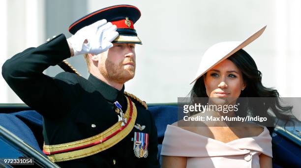 Prince Harry, Duke of Sussex and Meghan, Duchess of Sussex travel down The Mall in a horse drawn carriage during Trooping The Colour 2018 on June 9,...
