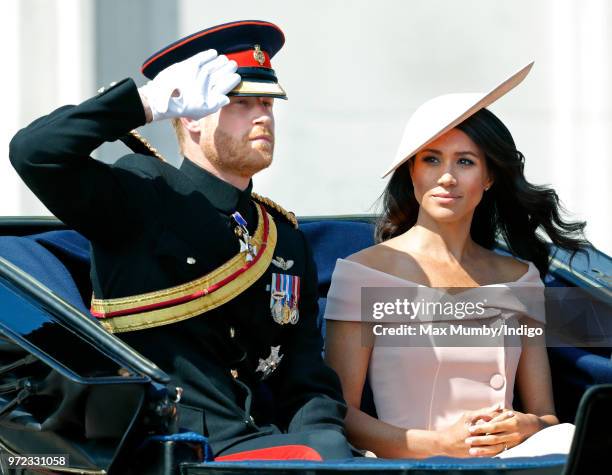 Prince Harry, Duke of Sussex and Meghan, Duchess of Sussex travel down The Mall in a horse drawn carriage during Trooping The Colour 2018 on June 9,...