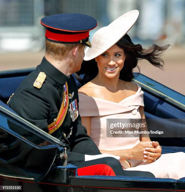 Prince Harry, Duke of Sussex and Meghan, Duchess of Sussex travel down The Mall in a horse drawn carriage during Trooping The Colour 2018 on June 9,...