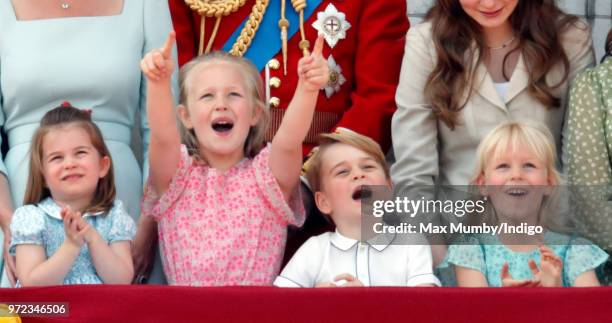 Princess Charlotte of Cambridge, Savannah Phillips, Prince George of Cambridge and Isla Phillips stand on the balcony of Buckingham Palace during...