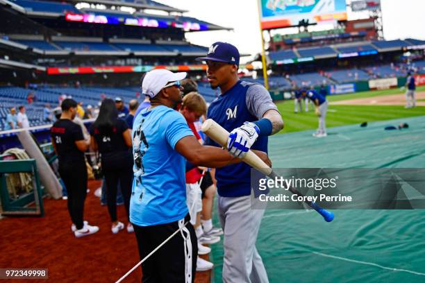 Orlando Arcia of the Milwaukee Brewers hugs a familiar person before the game against the Philadelphia Phillies at Citizens Bank Park on June 8, 2018...