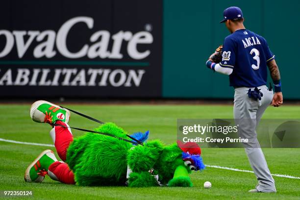 Phillie Phanatic jokes with Orlando Arcia of the Milwaukee Brewers before the game between the Philadelphia Phillies and the Milwaukee Brewers at...