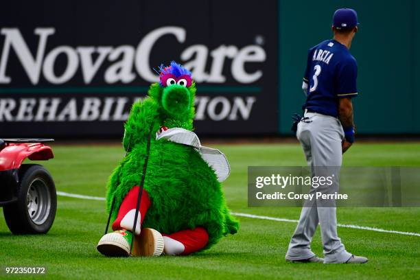 Phillie Phanatic jokes with Orlando Arcia of the Milwaukee Brewers before the game between the Philadelphia Phillies and the Milwaukee Brewers at...