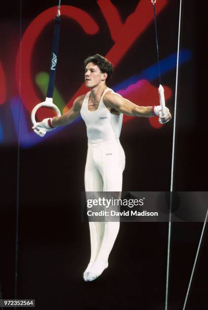Szilveszter Csollany of Hungary performs an Iron Cross on the still rings during the gymnastics competition of the 1990 Goodwill Games held from July...