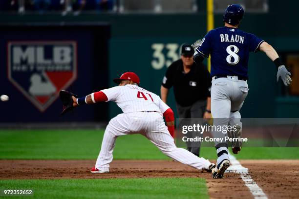 Carlos Santana of the Philadelphia Phillies stretches for an out against Ryan Braun of the Milwaukee Brewers during the third inning at Citizens Bank...