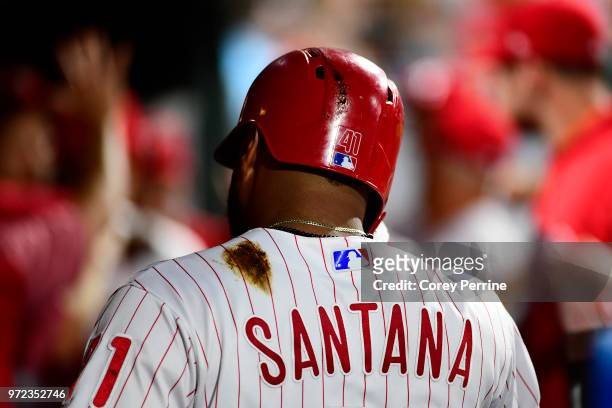 Carlos Santana of the Philadelphia Phillies walks in the dugout during the fourth inning against the Milwaukee Brewers at Citizens Bank Park on June...
