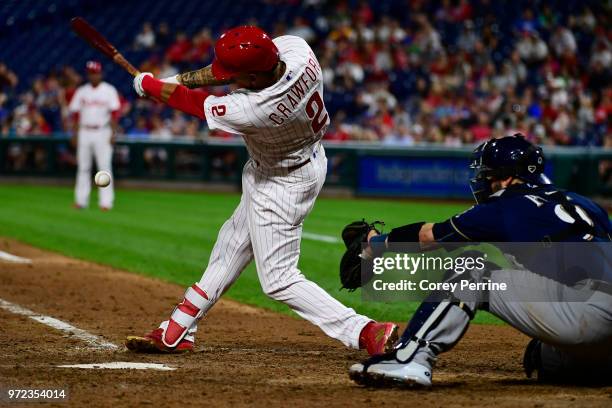 Crawford of the Philadelphia Phillies swings at a pitch as Manny Pina of the Milwaukee Brewers catches during the seventh inning at Citizens Bank...