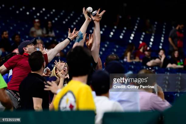 Fans catch a foul ball between the Philadelphia Phillies and the Milwaukee Brewers during the eighth inning at Citizens Bank Park on June 8, 2018 in...