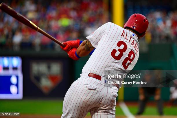 Jorge Alfaro of the Philadelphia Phillies swings at a pitch against the Milwaukee Brewers during the second inning at Citizens Bank Park on June 8,...