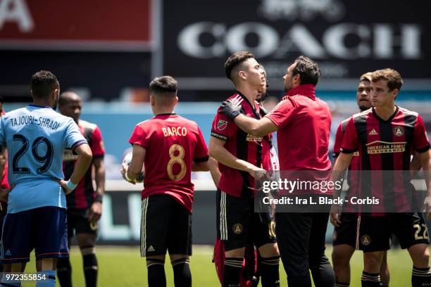 Miguel Almiron of Atlanta United is attended to after a injury to his shoulder during the MLS match between New York City FC and Atlanta United FC at...