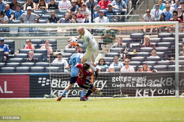 Goalkeeper Brad Guzan of Atlanta United jumps and stops the shot on goal by Jo Inge Berget of New York City during the match between New York City FC...