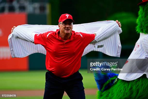 Danny Jackson, a former Phillies pitcher, tears off his shirt in recreating the 1993 moment when he helped defeat the Atlanta Braves and capturing...