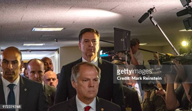 James Wolfe former director of security with the Senate Intelligence Committee escorts former FBI Director James Comey out of hearing room in the...