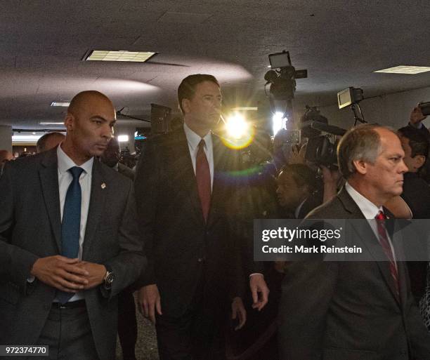 James Wolfe former director of security with the Senate Intelligence Committee escorts former FBI Director James Comey out of hearing room in the...